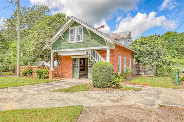 902 SE 2nd St, Moultrie, GA 31776 - view of front of property with brick siding, a front yard, and stairs