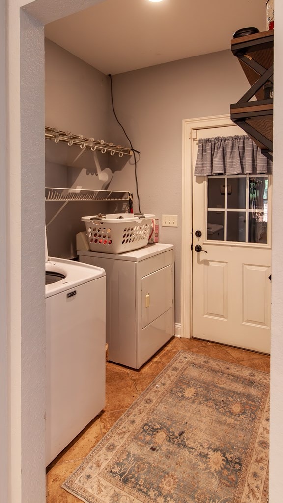 110 Quail Rdg, Ochlocknee, GA 31773 - laundry room with washing machine and dryer and light tile patterned floors