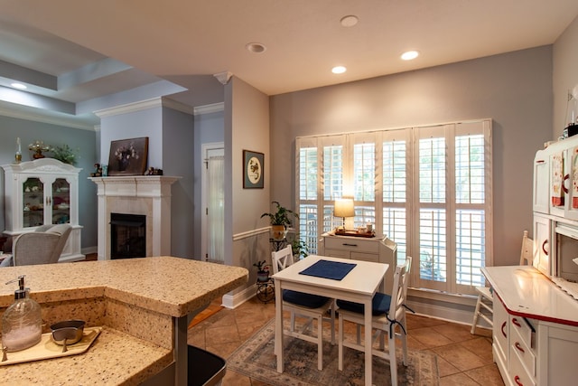 110 Quail Rdg, Ochlocknee, GA 31773 - kitchen with crown molding, a fireplace, recessed lighting, light stone counters, and tile patterned flooring
