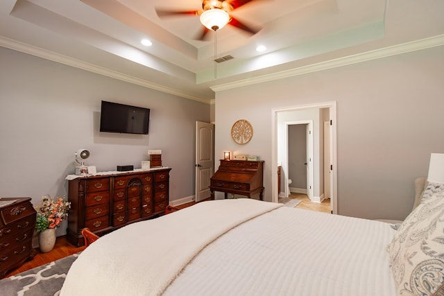 110 Quail Rdg, Ochlocknee, GA 31773 - bedroom with a tray ceiling, ornamental molding, recessed lighting, a ceiling fan, and wood finished floors