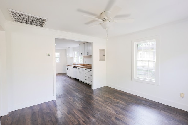 101 Hambleton St, Thomasville, GA 31792 - unfurnished living room with ceiling fan, electric panel, dark wood-style flooring, and ornamental molding