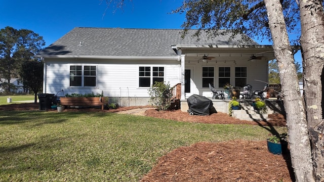 rear view of house featuring a yard, a patio, roof with shingles, and a ceiling fan