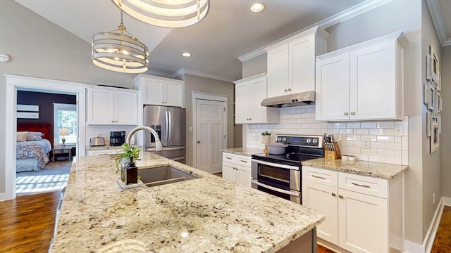 kitchen featuring under cabinet range hood, a sink, appliances with stainless steel finishes, white cabinets, and crown molding