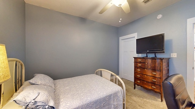 bedroom with visible vents, a ceiling fan, and carpet