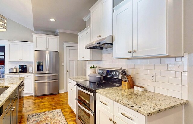 kitchen featuring under cabinet range hood, white cabinetry, appliances with stainless steel finishes, crown molding, and dark wood-style flooring