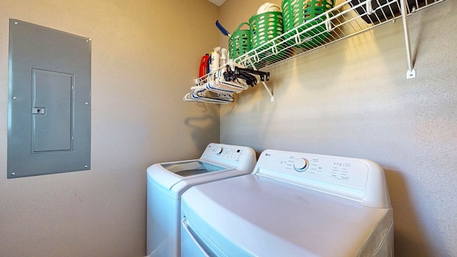 washroom featuring electric panel, laundry area, and washer and dryer