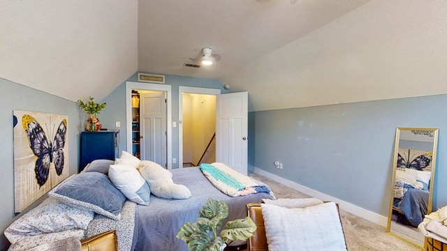 carpeted bedroom featuring visible vents, baseboards, and lofted ceiling