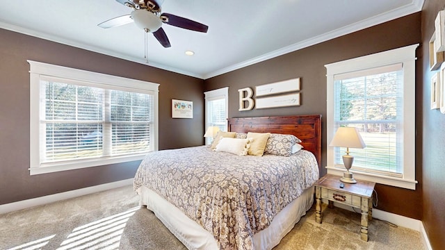 bedroom with a ceiling fan, crown molding, baseboards, and carpet floors