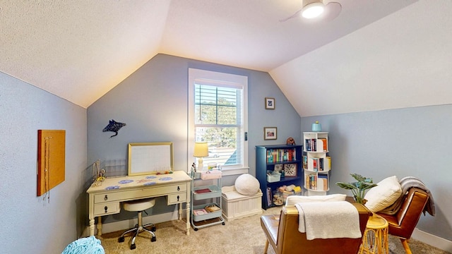 office area featuring lofted ceiling, a ceiling fan, and carpet floors