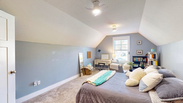 carpeted bedroom featuring baseboards, lofted ceiling, and a ceiling fan