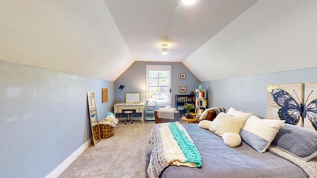 bedroom featuring light colored carpet, baseboards, lofted ceiling, and ceiling fan