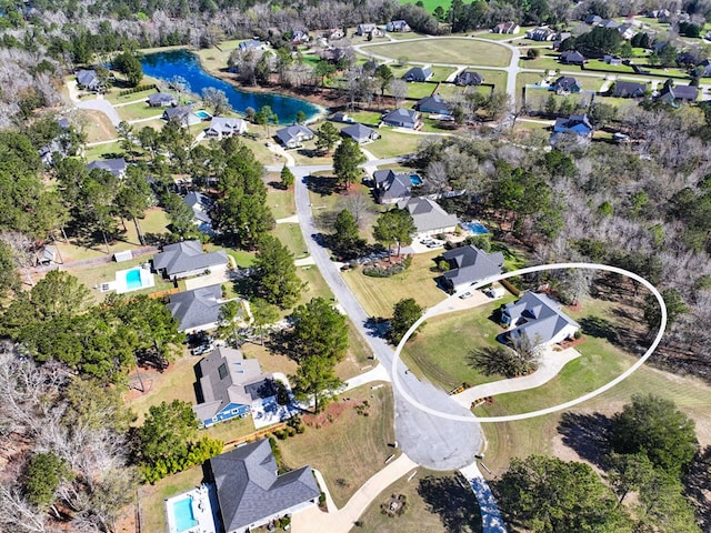 drone / aerial view featuring a residential view and a water view