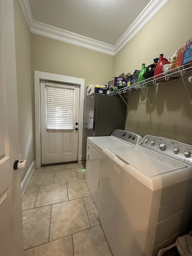 clothes washing area featuring light tile patterned floors, ornamental molding, and independent washer and dryer