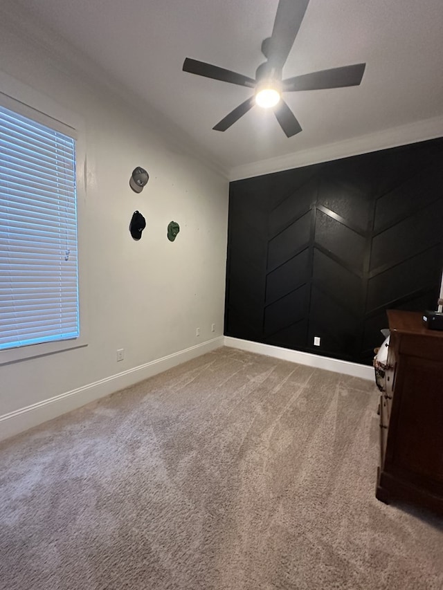 unfurnished bedroom featuring crown molding, ceiling fan, and light carpet