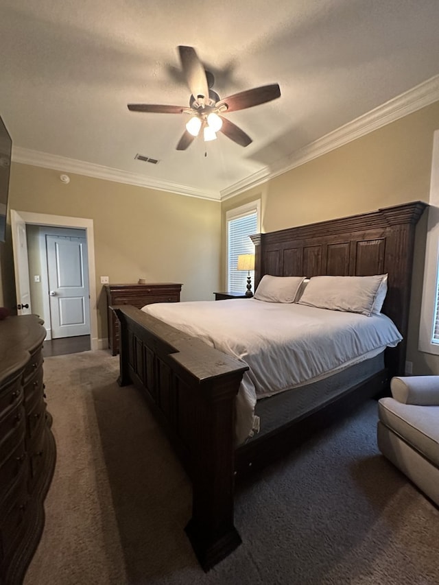 carpeted bedroom featuring crown molding and ceiling fan