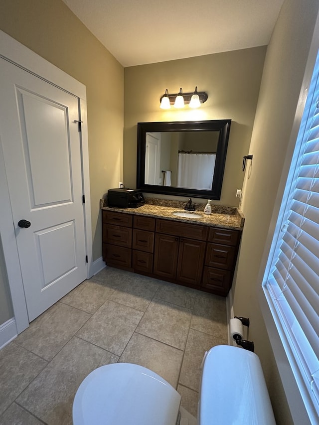 bathroom featuring vanity and toilet