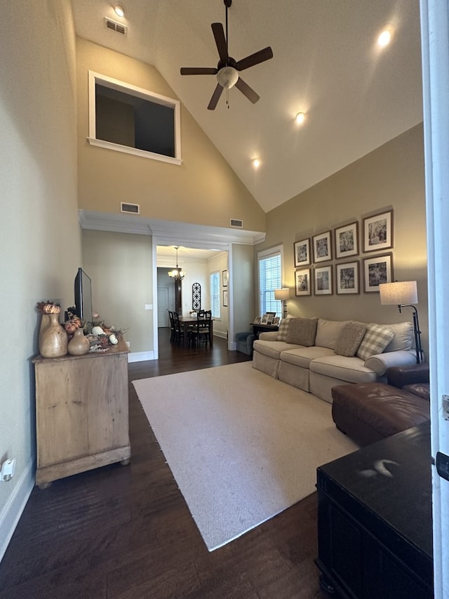 living room featuring high vaulted ceiling, ceiling fan with notable chandelier, and dark hardwood / wood-style flooring