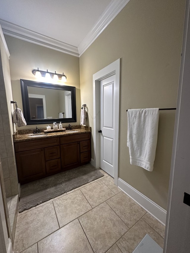 bathroom featuring tile patterned flooring, ornamental molding, and vanity