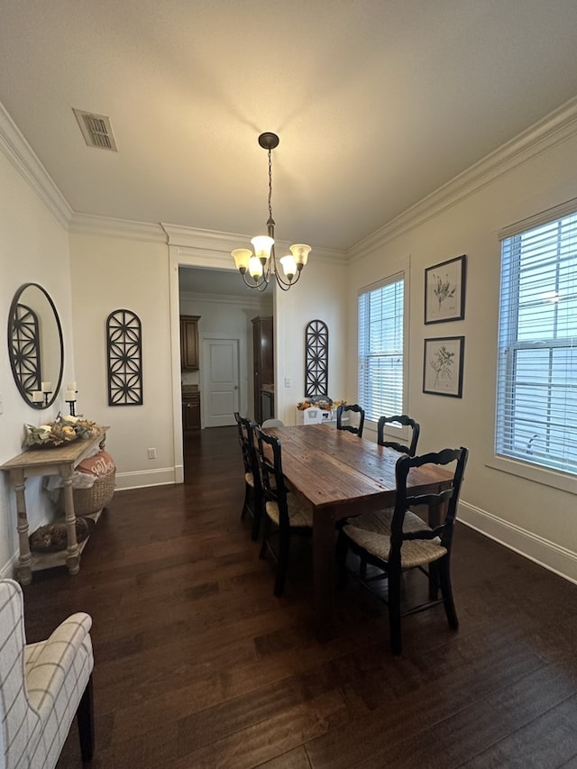 dining room with crown molding, a wealth of natural light, and a chandelier