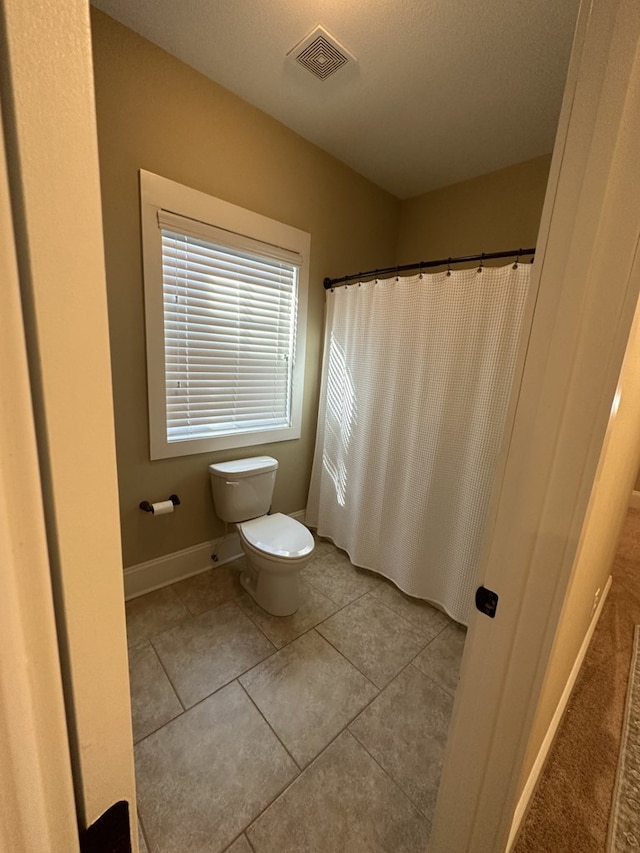 bathroom featuring tile patterned flooring and toilet