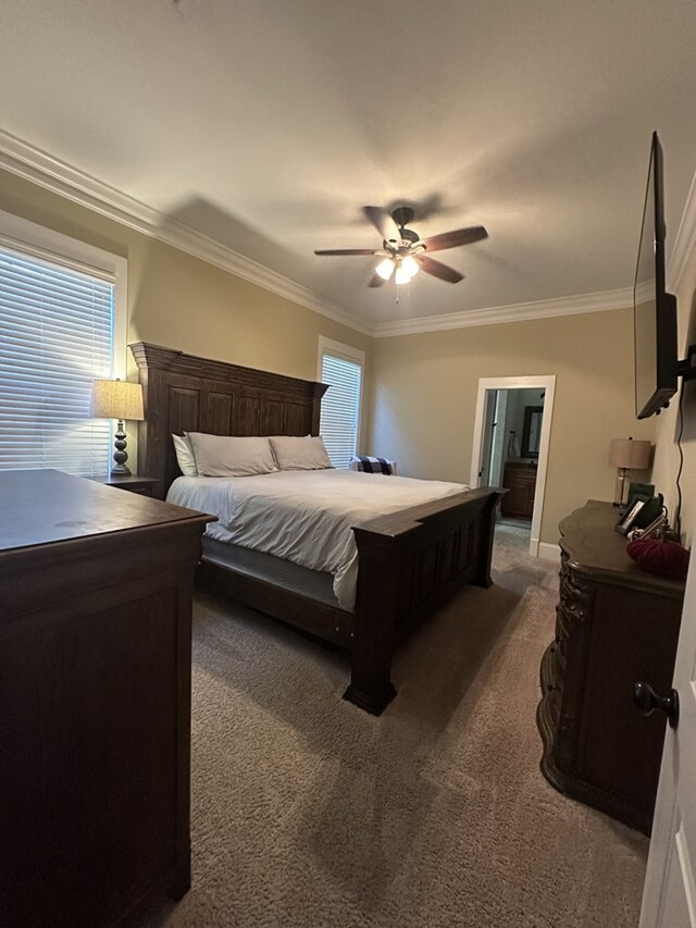 carpeted bedroom featuring crown molding and ceiling fan