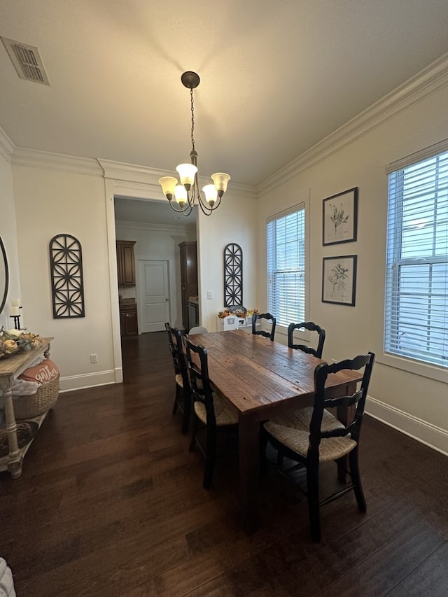 dining area with ornamental molding, dark hardwood / wood-style flooring, and a notable chandelier