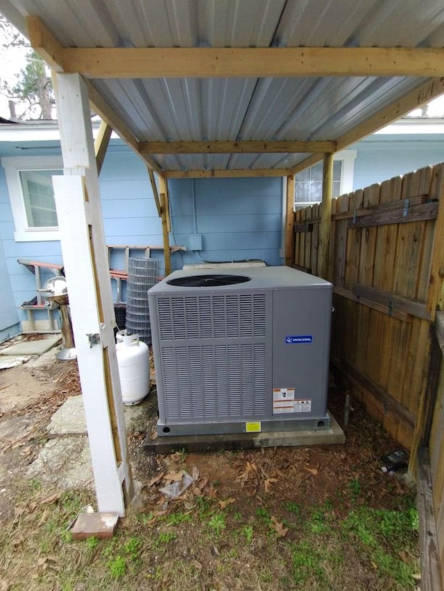 details featuring fence and central air condition unit