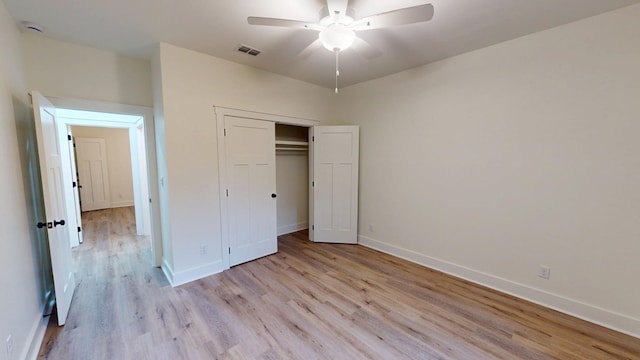 unfurnished bedroom featuring ceiling fan, light hardwood / wood-style flooring, and a closet