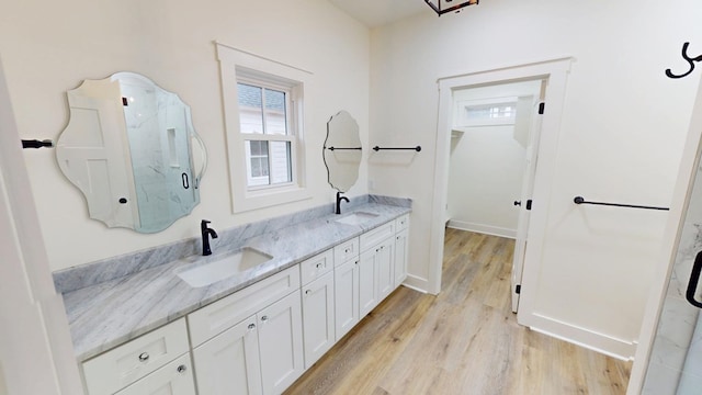 bathroom featuring a shower with door, vanity, and wood-type flooring