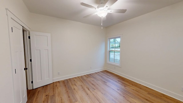 spare room featuring light hardwood / wood-style flooring and ceiling fan