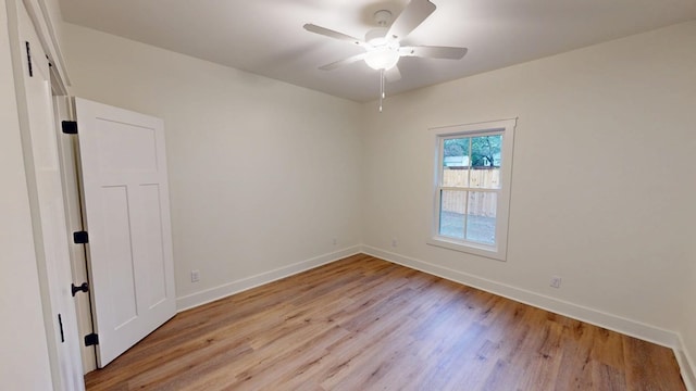 empty room with ceiling fan and light hardwood / wood-style flooring