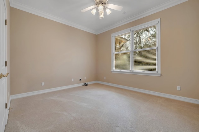 empty room with crown molding, light colored carpet, and ceiling fan