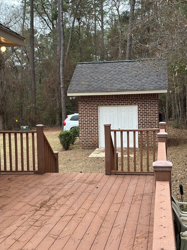 wooden terrace featuring an outdoor structure