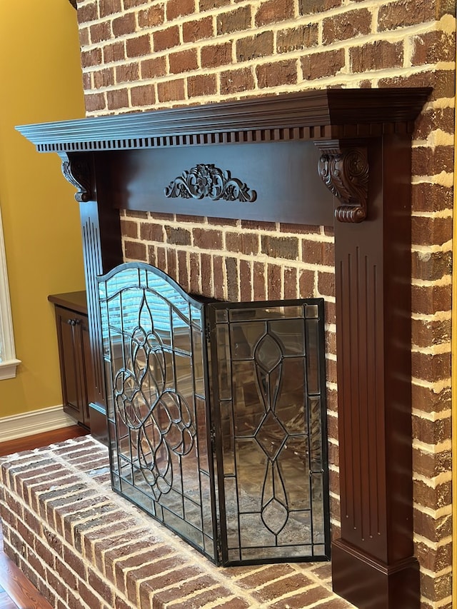 details with a brick fireplace