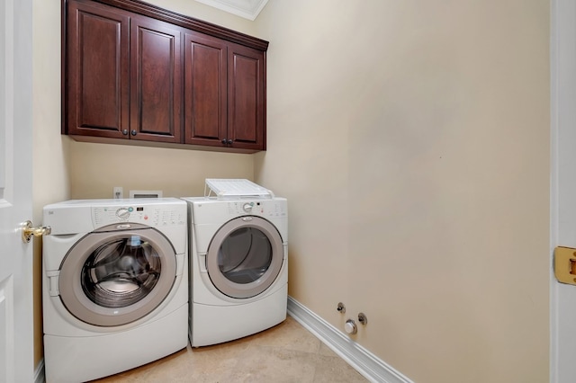 clothes washing area featuring cabinets, washing machine and clothes dryer, and light tile patterned floors