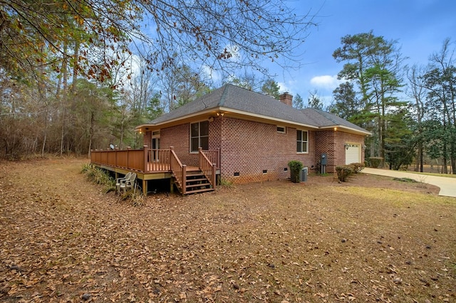 back of property with a wooden deck, a garage, and central air condition unit