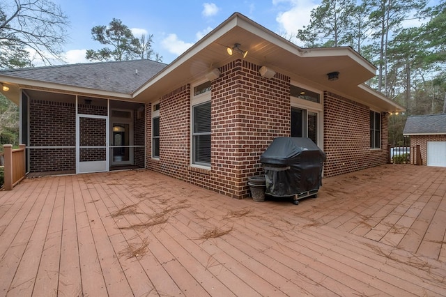 wooden deck featuring a grill and a patio area