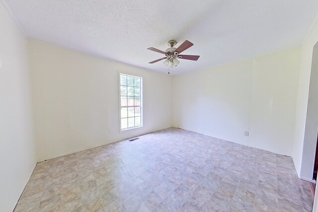 452 Bn Railroad Cir, Boston, GA 31626 - spare room featuring ceiling fan, tile patterned floors, and a textured ceiling