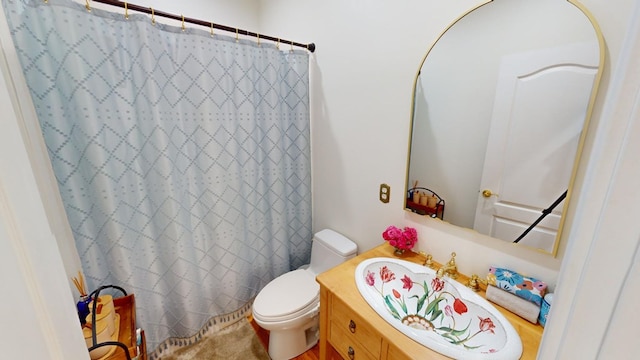 bathroom featuring walk in shower, vanity, and toilet