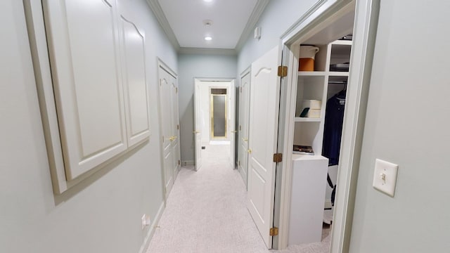 hallway featuring light colored carpet and ornamental molding