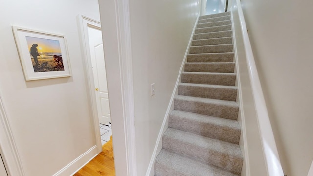 staircase featuring hardwood / wood-style flooring