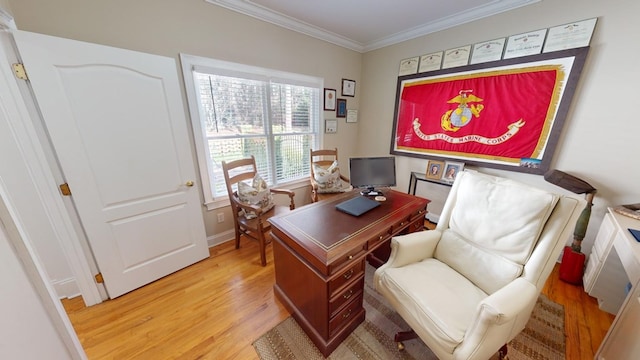 office area with light hardwood / wood-style flooring and ornamental molding