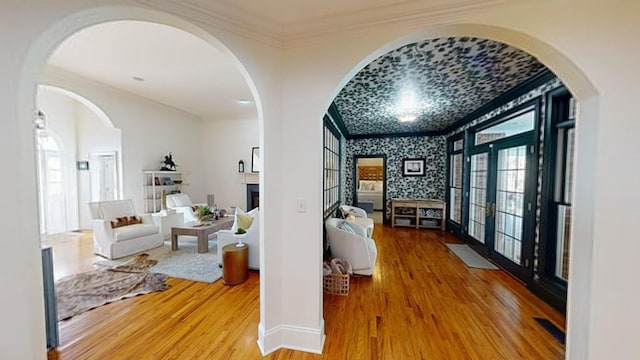 hallway featuring crown molding, french doors, and hardwood / wood-style flooring