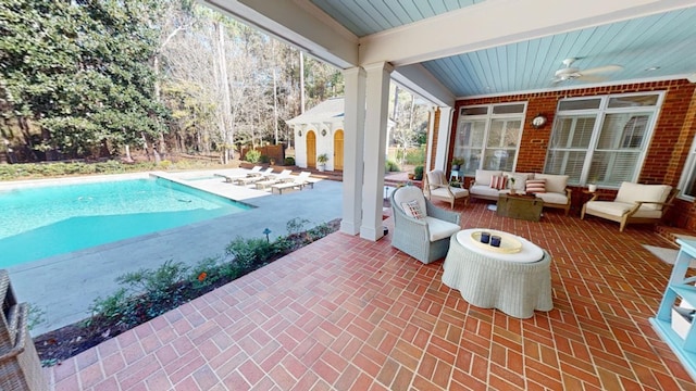 view of swimming pool with ceiling fan, an outdoor living space, and a patio