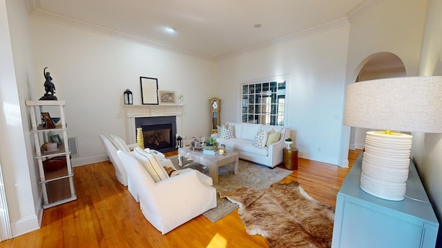 living room with crown molding and hardwood / wood-style flooring