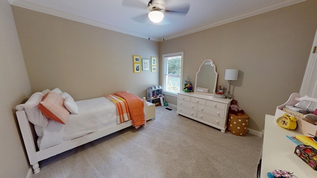 bedroom with ceiling fan, ornamental molding, and light carpet