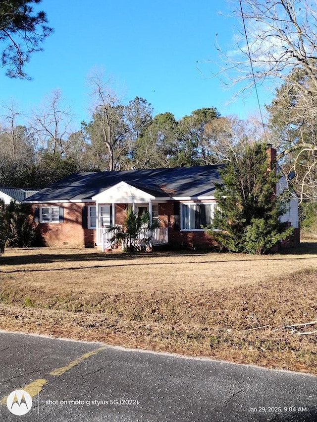 single story home featuring covered porch