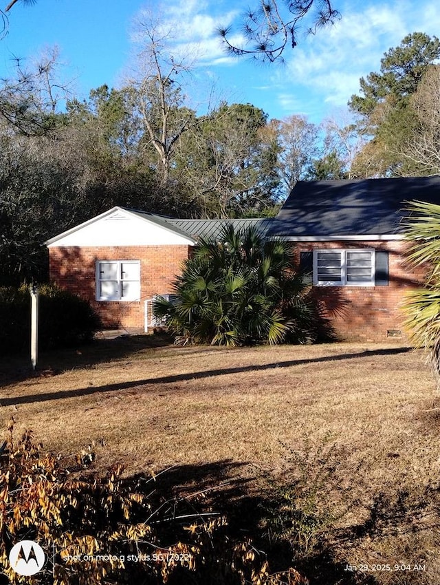 view of property exterior with a yard