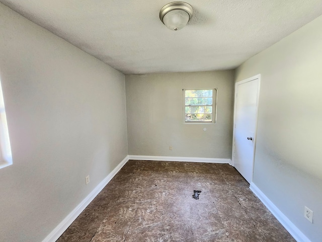 spare room with a textured ceiling