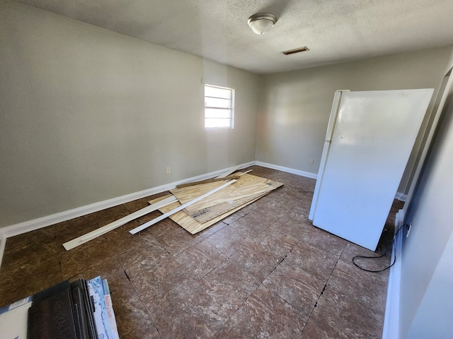 empty room with a textured ceiling